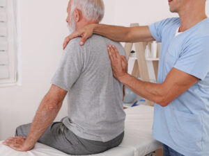 Registered chiropractor performing a back and spinal assessment on a patient during an initial consultation in Ajax.